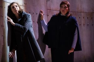 Bess (soprano Kiera Duffy) phones Jan out on the rig, while her sister-in-law, Dodo McNeill (mezzo-soprano Eve Gigliotti), looks on. Photo by Dominic M. Mercier for Opera Philadelphia.