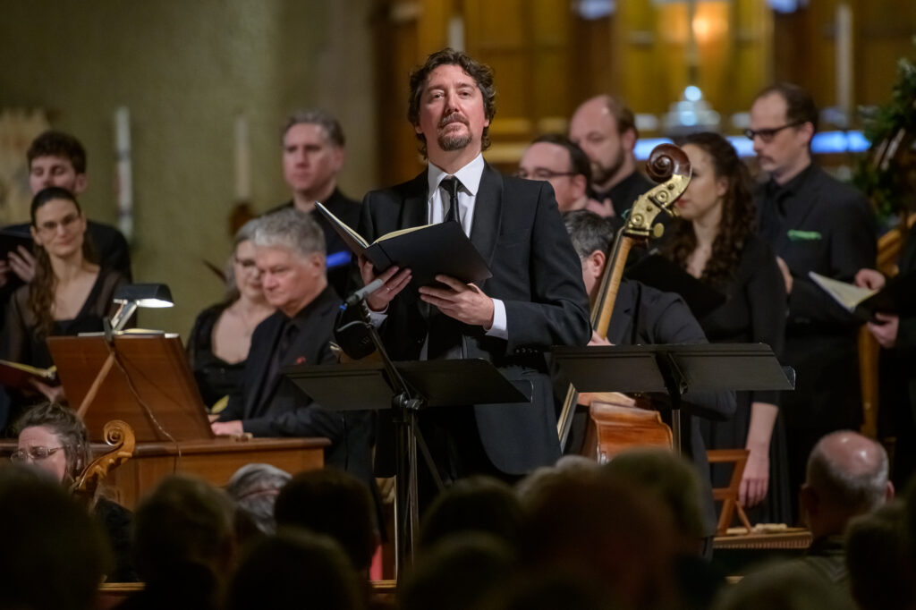 Baritone Alexander Dobson in front of the Ottawa Bach Choir and Theatre of Early Music baroque orchestra