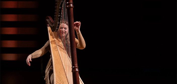 Harpist Bridget Kibbey on stage at Koerner Hall