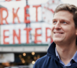 Portrait of James Ethnes in front of red neon Market sign