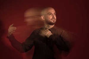 Franco Fagioli, blurred portrait on a red background