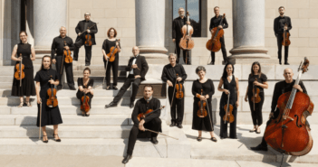 I Musici de Montréal - Chamber Orchestra standing on beige stairs