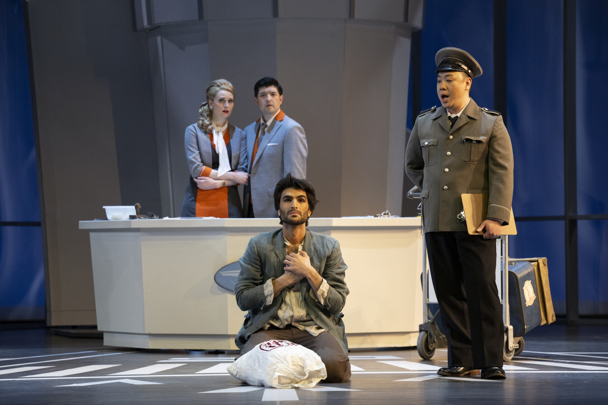 Alex Hetherington as the Stewardess, Clarence Frazer as the Steward, Cameron Shahbazi as the Refugee, and Henry Chen as the Immigration Officer in Vancouver Opera’s 2025 production of Flight