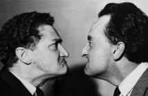 Black and white image of two men glaring at eachother