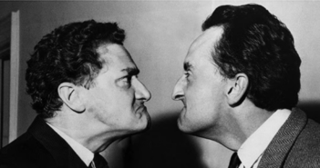 Black and white image of two men glaring at eachother