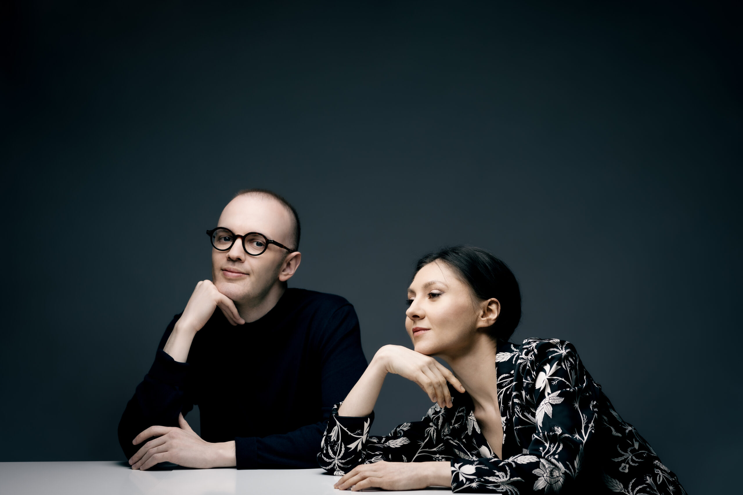 Piano duo leaning on table