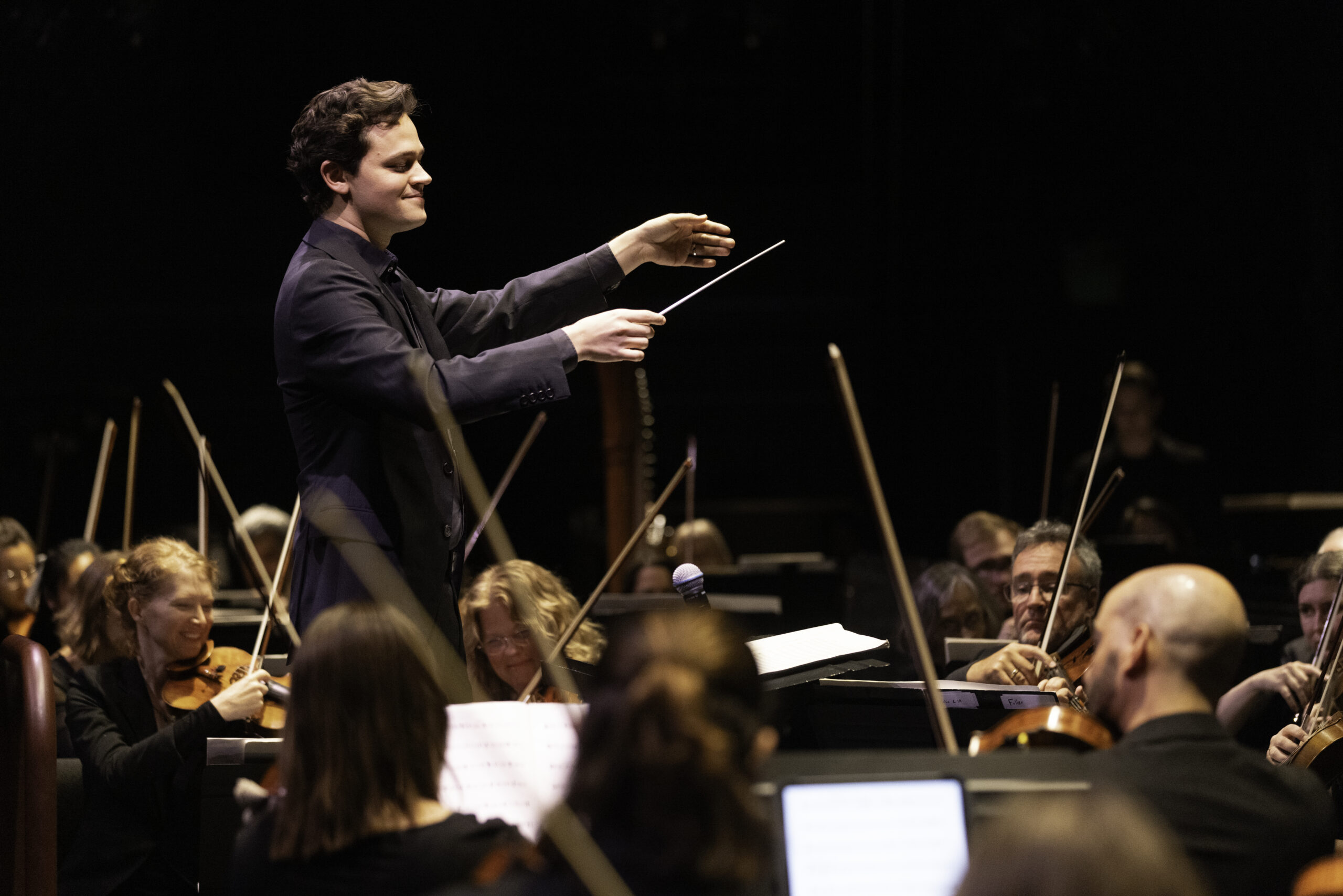 Toronto-native Nicholas Sharma conducting an orchestra