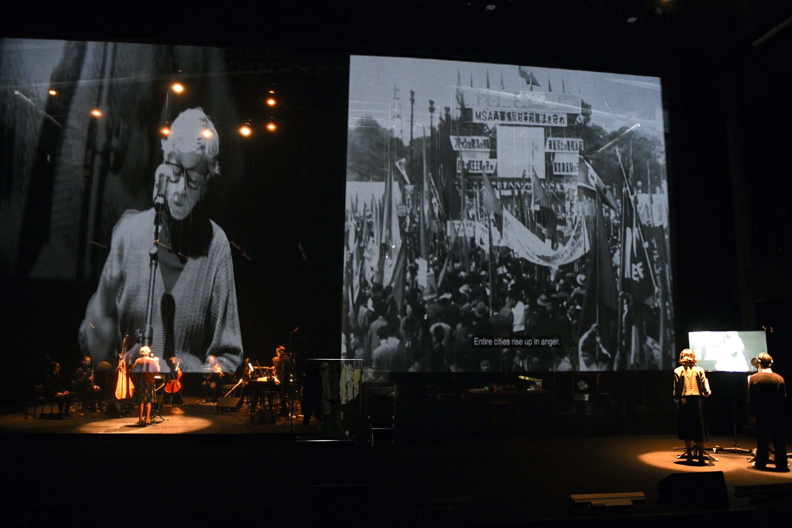 Plus de 400 photos tirées du film Hiroshima mon amour sont projetées sur l’écran qui traverse la scène. Crédit photo: Valérie Remise