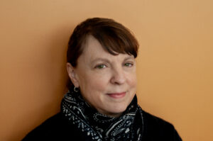 A headshot of Claire Gignac wearing formal attire.